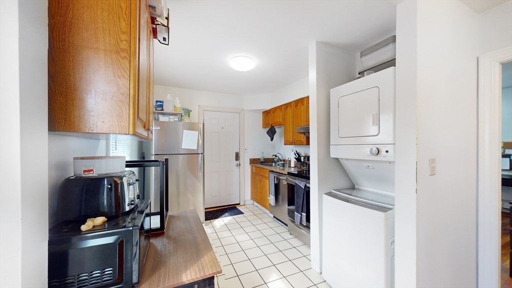 479 High Street Dedham, MA 02026 - Photo 10 of 22 a kitchen with a refrigerator and a stove
