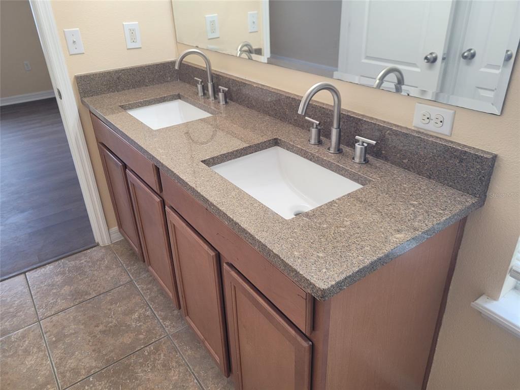 1555 Scarlet Oak Loop, Unit 113A Winter Garden, FL 34787 - Photo 11 of 11 a bathroom with sink and mirror