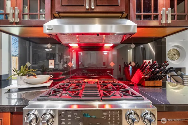 a kitchen with a stove a sink and cabinets