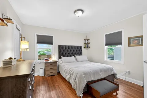 a bedroom with a bed window and a desk