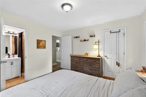 a bedroom with a bed and a dresser