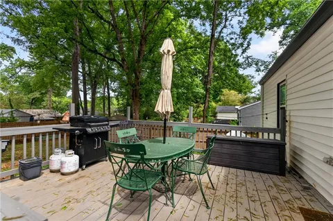 a view of backyard with seating space and trees