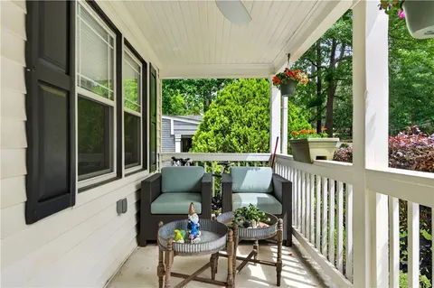 a balcony with furniture and garden view
