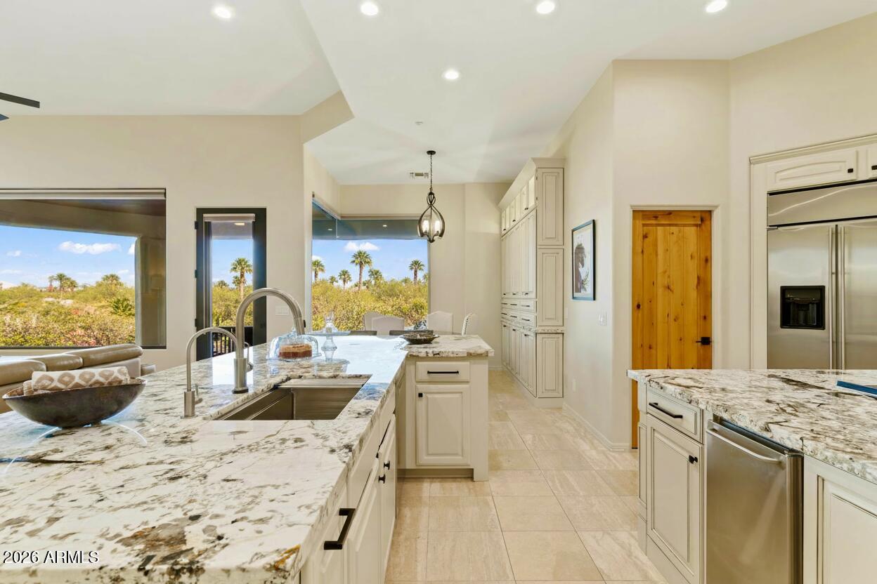 15730 East Eagle Crest Road Fountain Hills, AZ 85268 - Photo 16 of 77 a kitchen with stainless steel appliances kitchen island granite countertop a sink stove and refrigerator