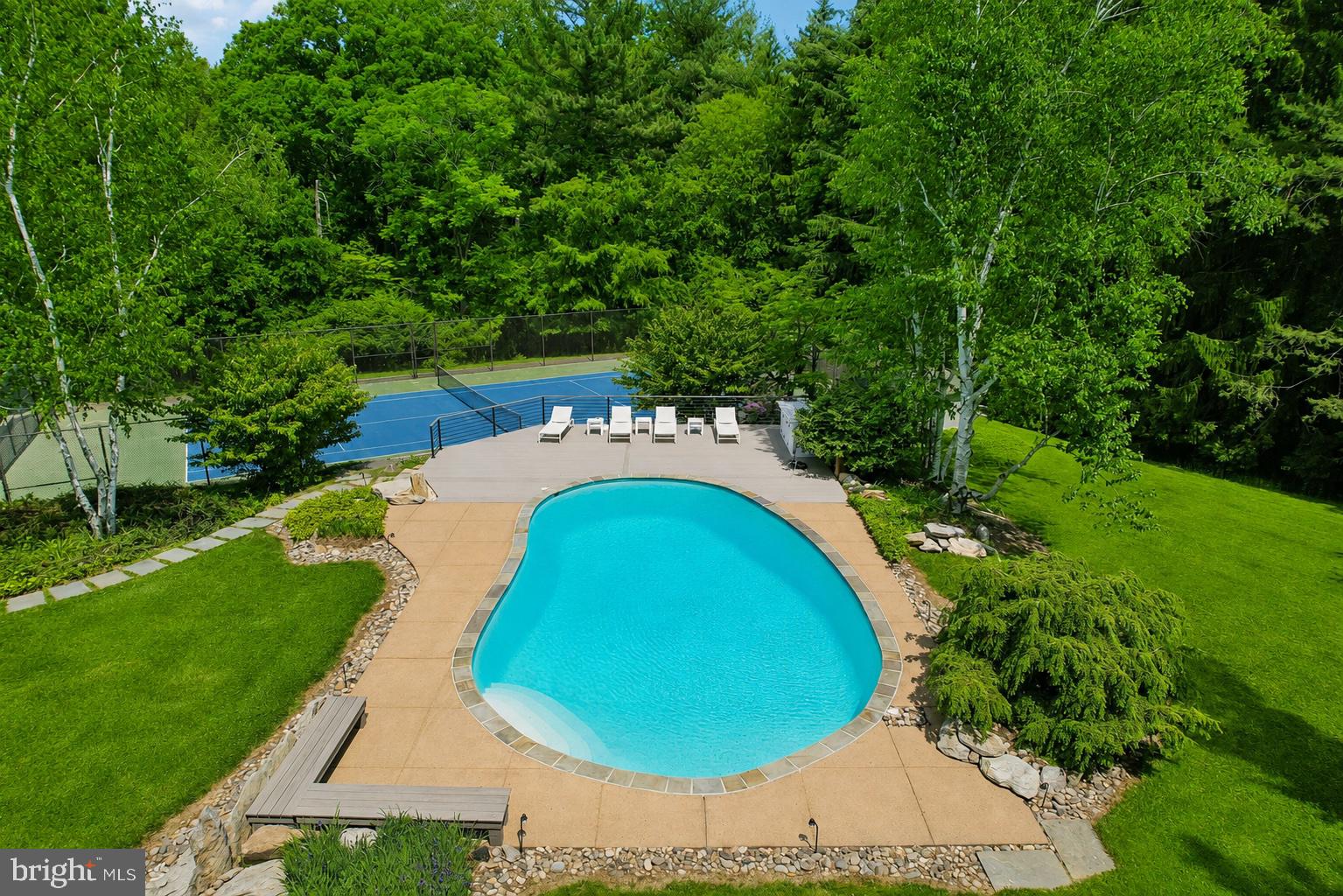 1673 Paper Mill Road Jenkintown, PA 19046 - Photo 65 of 73 a view of a swimming pool in he middle of the green field