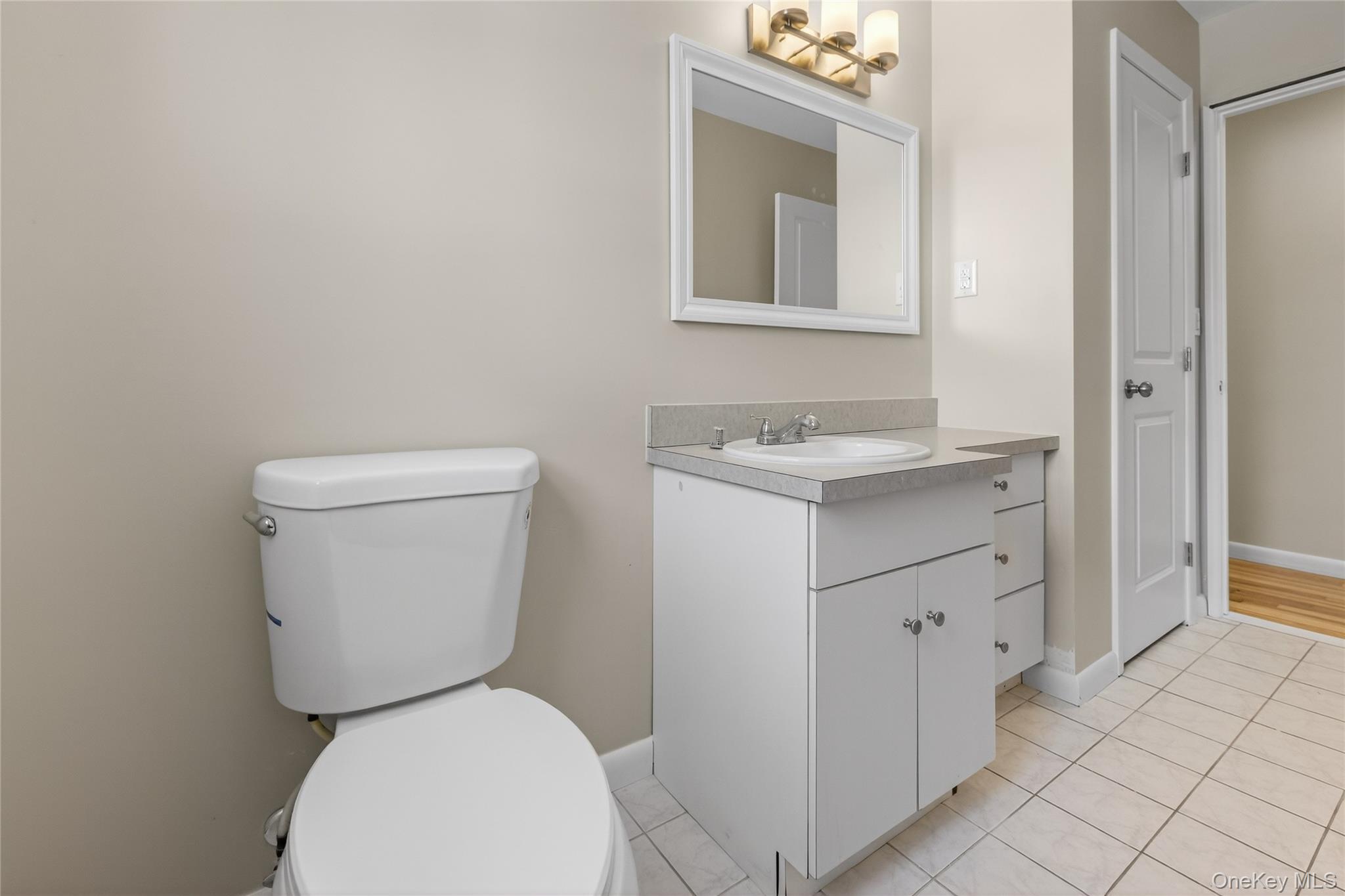 676-678 Oak Summit Road Millbrook, NY 12545 - Photo 12 of 22 a white toilet sitting next to a bathroom sink