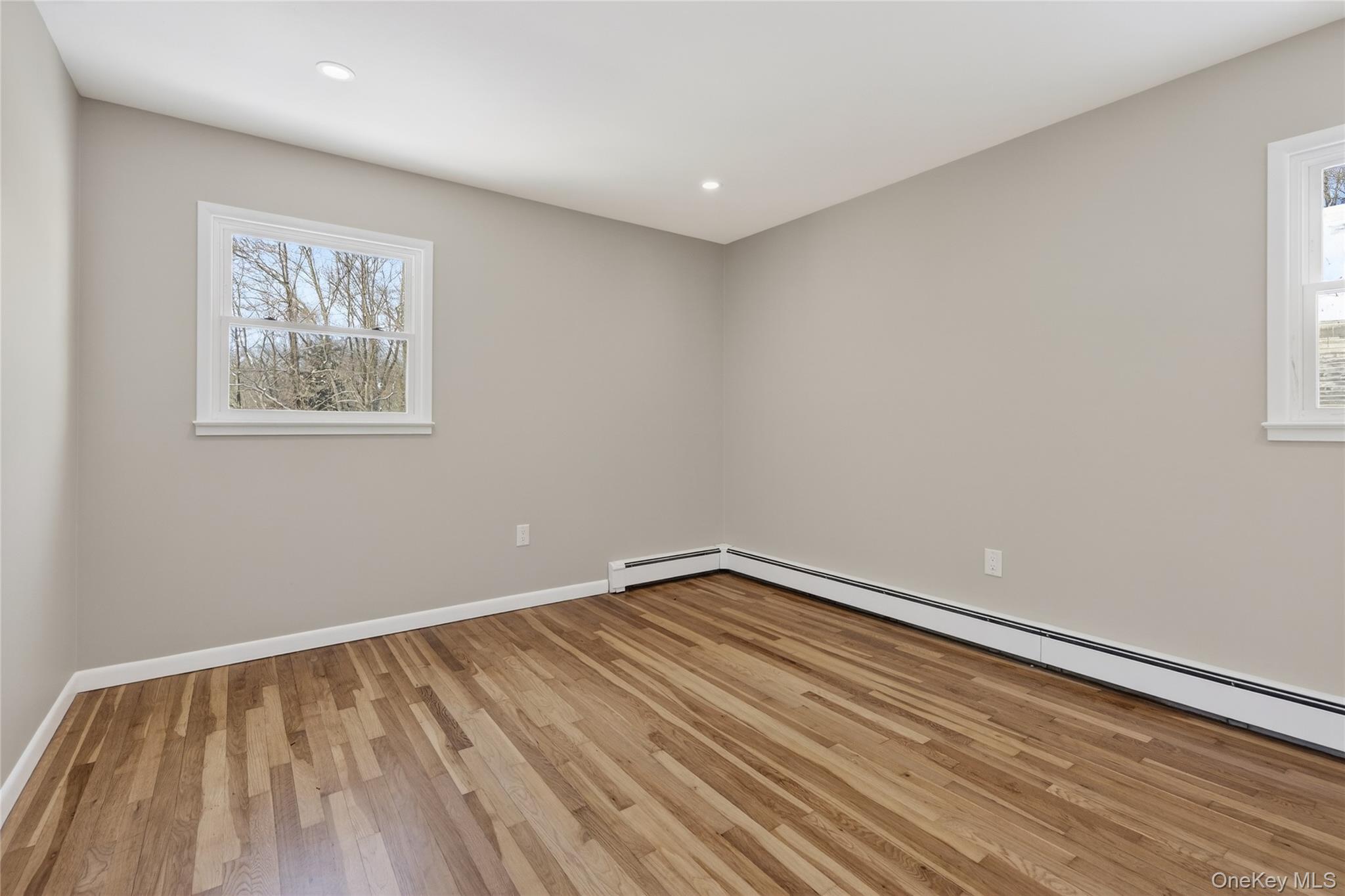 676-678 Oak Summit Road Millbrook, NY 12545 - Photo 14 of 22 a view of an empty room with wooden floor and a window