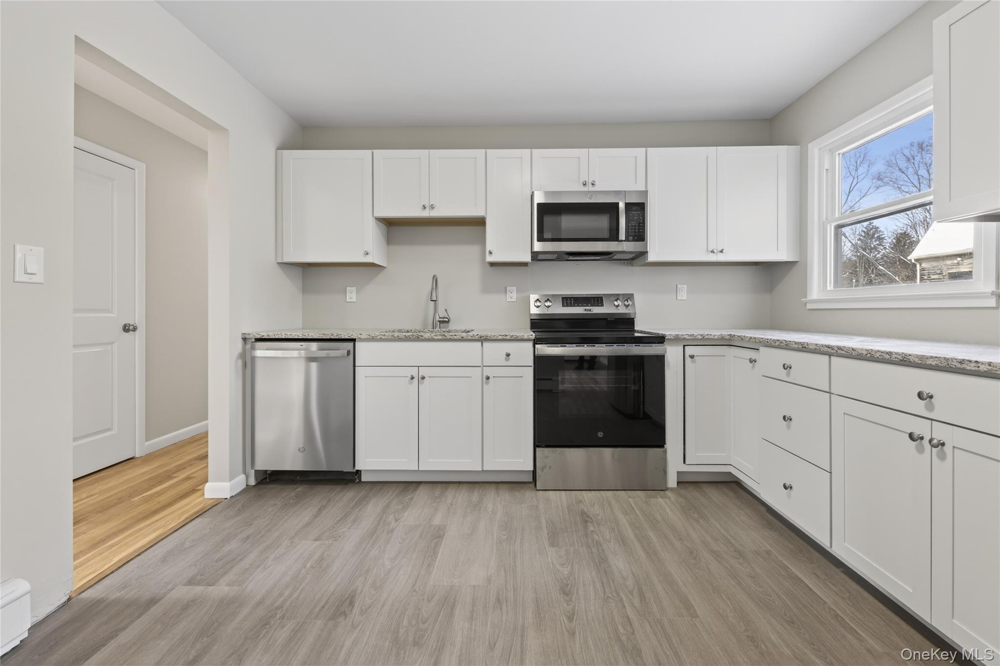 676-678 Oak Summit Road Millbrook, NY 12545 - Photo 2 of 22 a kitchen with stainless steel appliances a white cabinets and sink