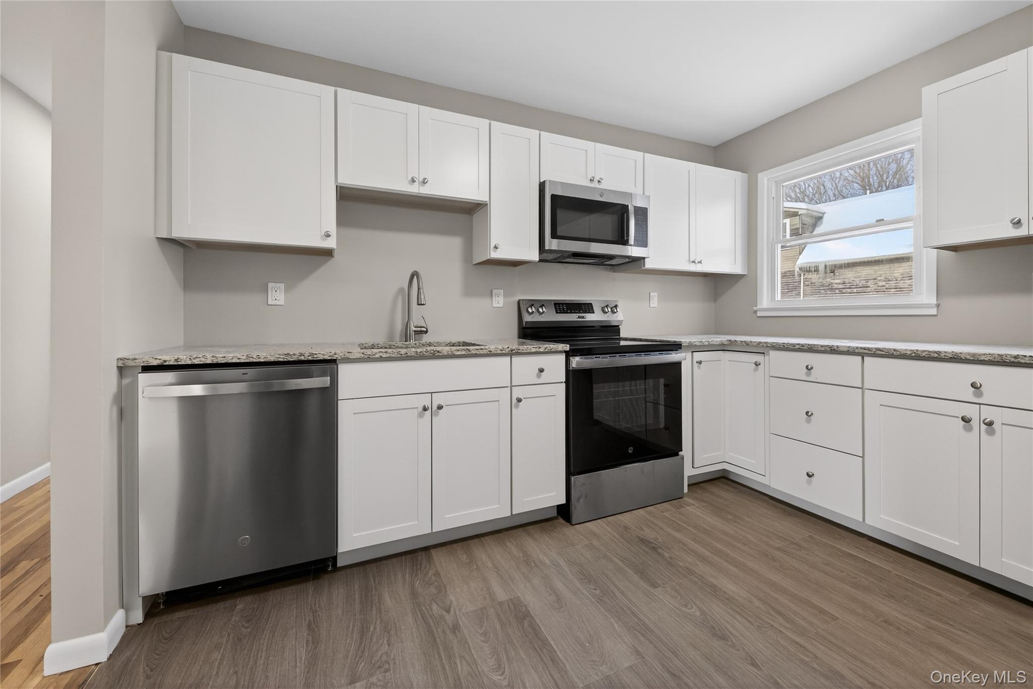 676-678 Oak Summit Road Millbrook, NY 12545 - Photo 3 of 22 a kitchen with white cabinets stainless steel appliances and sink