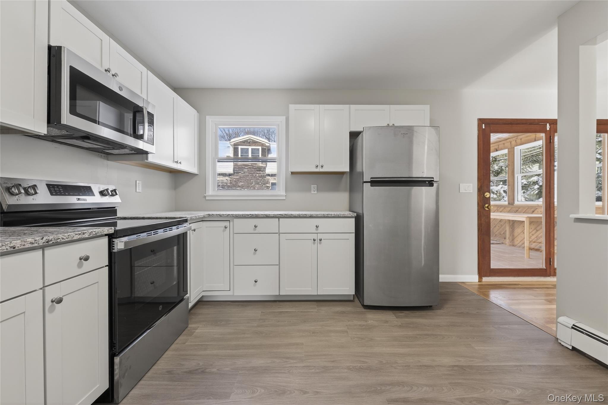 676-678 Oak Summit Road Millbrook, NY 12545 - Photo 4 of 22 a kitchen with stainless steel appliances a refrigerator stove and sink
