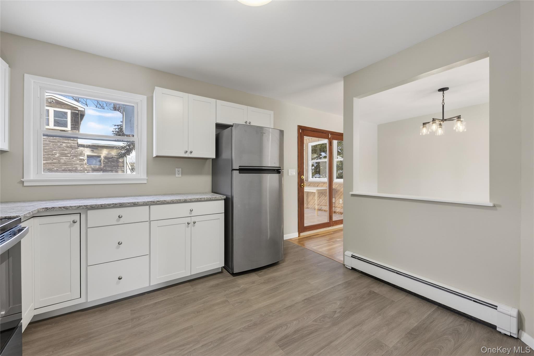 676-678 Oak Summit Road Millbrook, NY 12545 - Photo 5 of 22 a kitchen with a refrigerator a sink and dishwasher with wooden floor