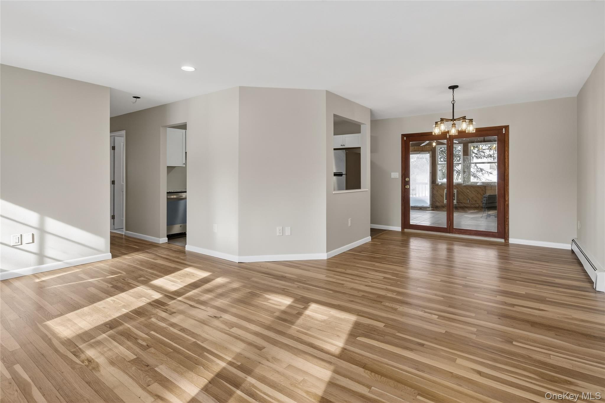 676-678 Oak Summit Road Millbrook, NY 12545 - Photo 6 of 22 a view of a livingroom with wooden floor window and a kitchen