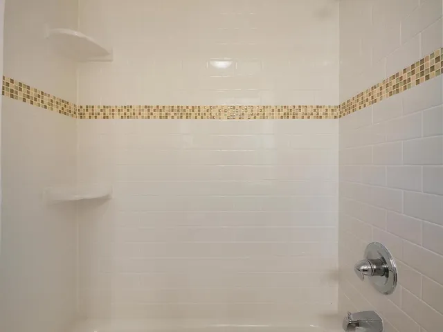 a bathroom with a shower and a shower