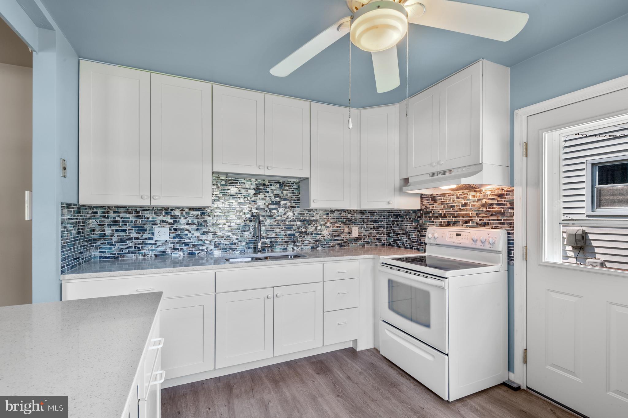 1013 Orems Road Baltimore, MD 21220 - Photo 14 of 37 a kitchen with white cabinets and white appliances