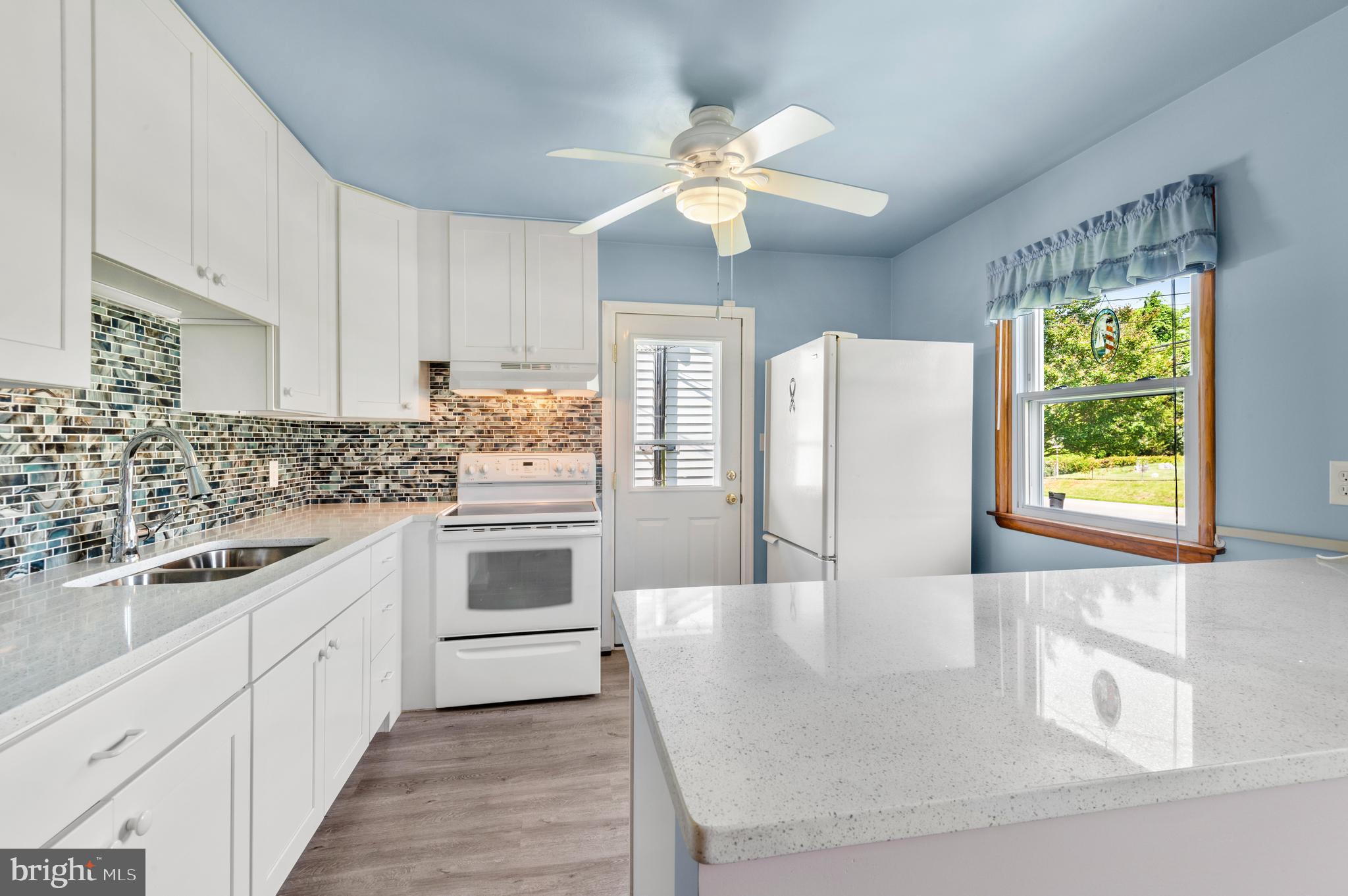 1013 Orems Road Baltimore, MD 21220 - Photo 2 of 37 a kitchen with stainless steel appliances granite countertop a sink dishwasher and white cabinets with wooden floor