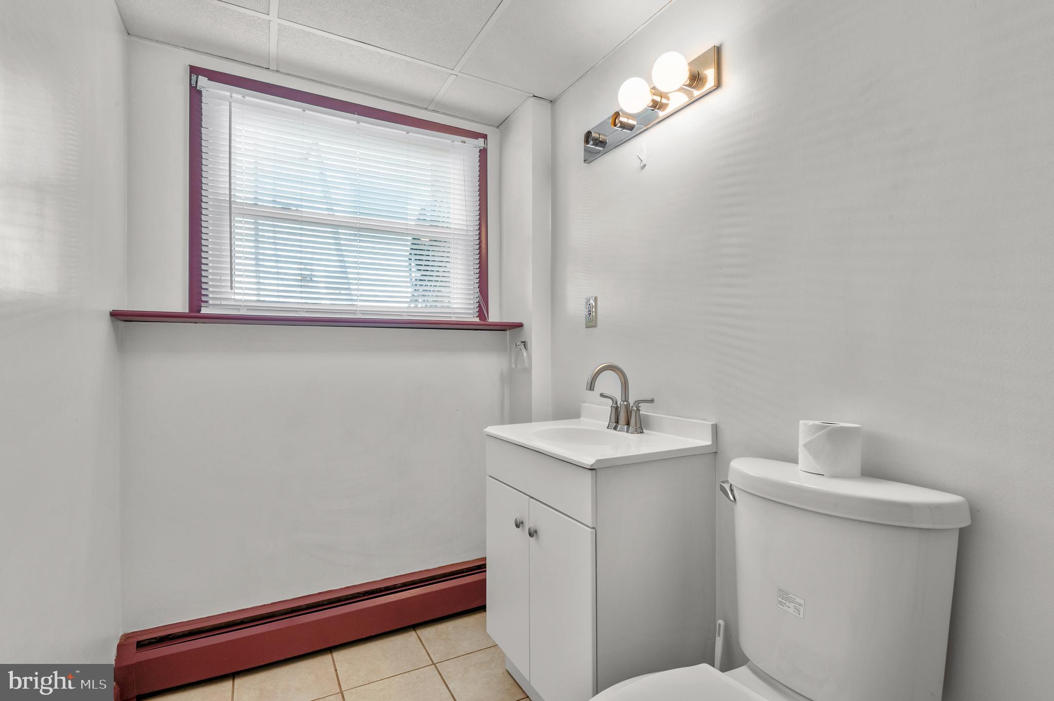 1013 Orems Road Baltimore, MD 21220 - Photo 28 of 37 a bathroom with a toilet sink and mirror