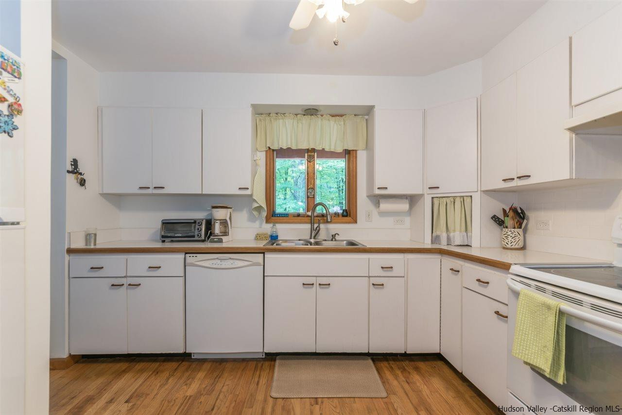 366 Buck Road Stone Ridge, NY 12484 - Photo 11 of 26 a kitchen with sink cabinets and window