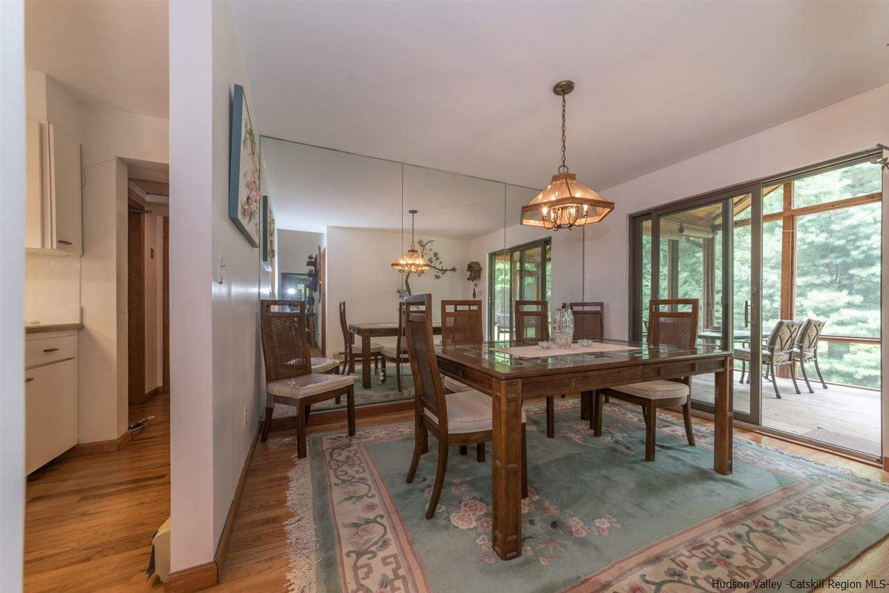 366 Buck Road Stone Ridge, NY 12484 - Photo 13 of 26 a view of a dining room with furniture window and wooden floor