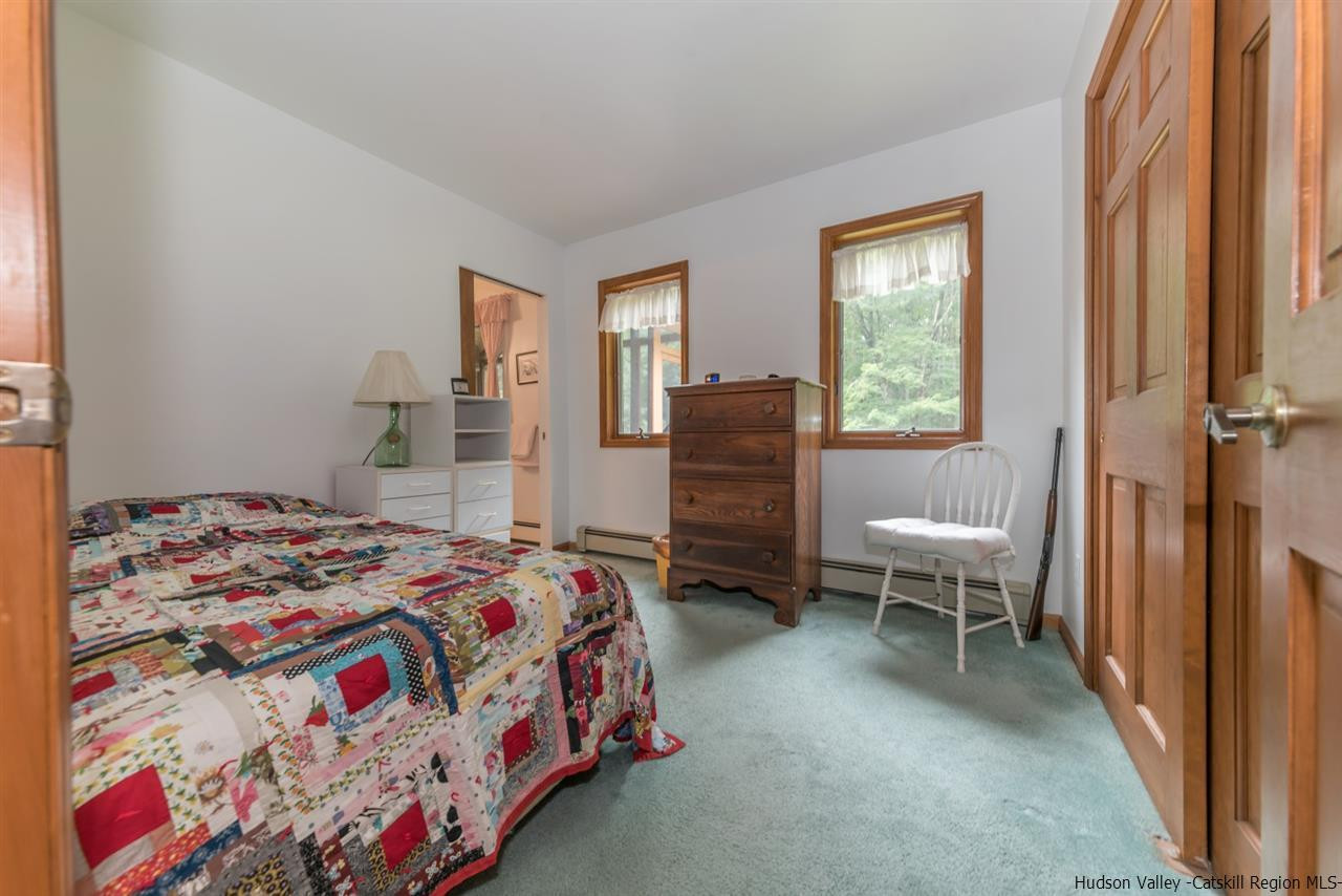 366 Buck Road Stone Ridge, NY 12484 - Photo 18 of 26 a bedroom with a bed and wooden floor