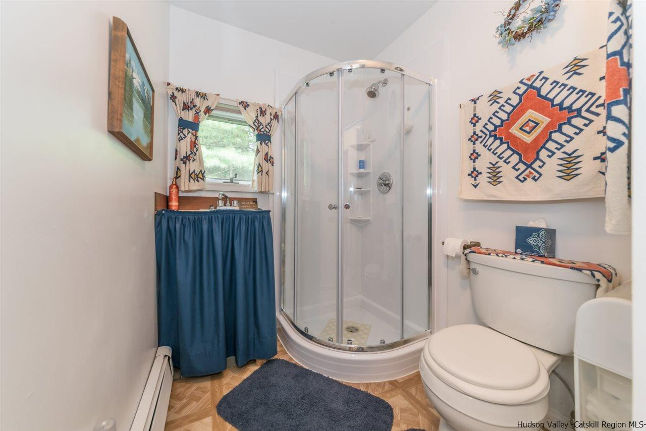 366 Buck Road Stone Ridge, NY 12484 - Photo 20 of 26 a white toilet sitting next to a bathroom sink