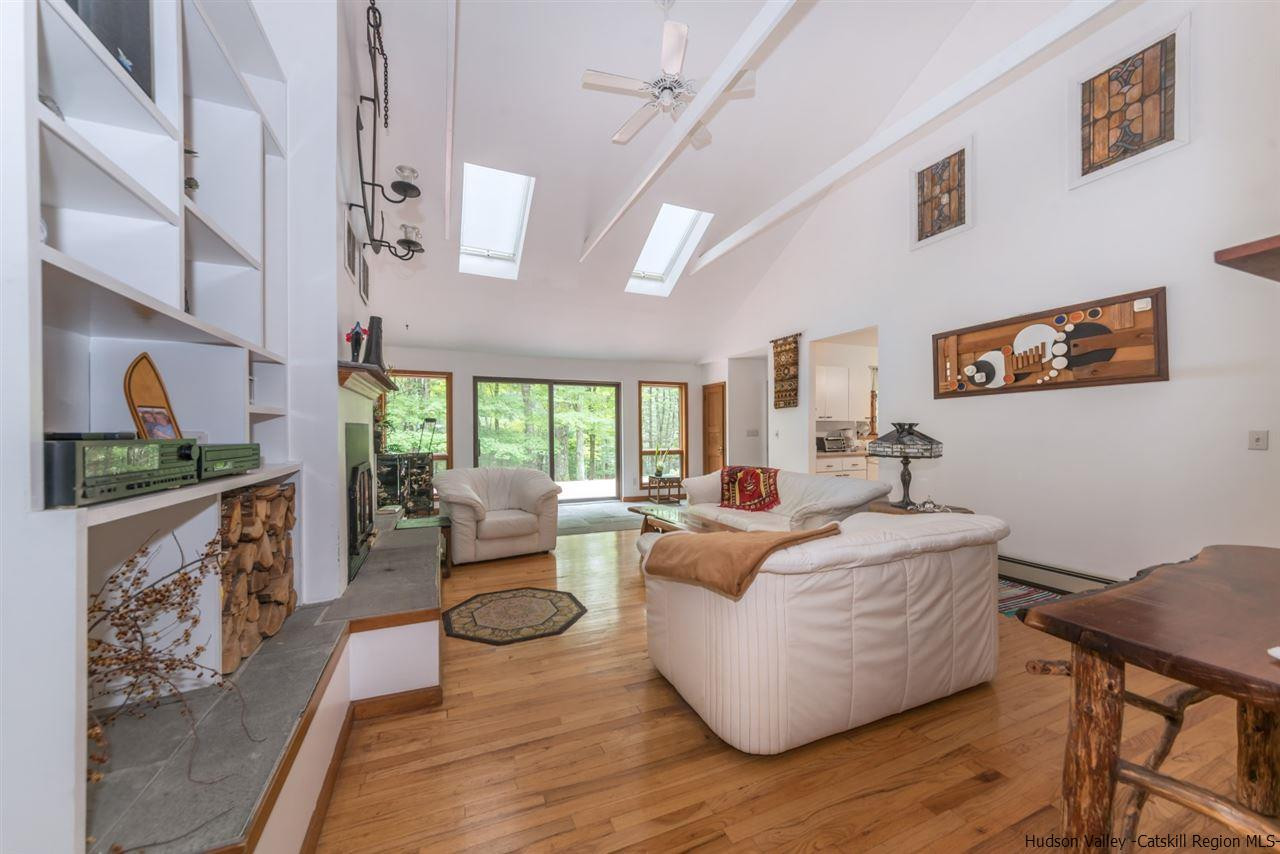 366 Buck Road Stone Ridge, NY 12484 - Photo 6 of 26 a living room with fireplace furniture and a large window