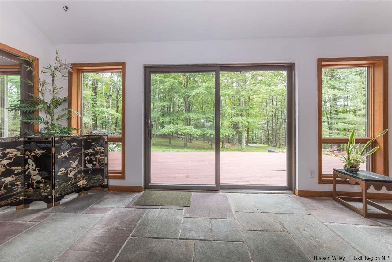 366 Buck Road Stone Ridge, NY 12484 - Photo 9 of 26 a living room with furniture and large windows