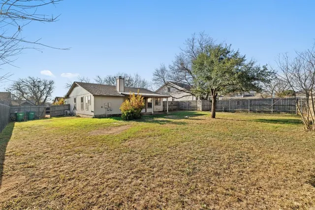 a house view with swimming pool in front of it