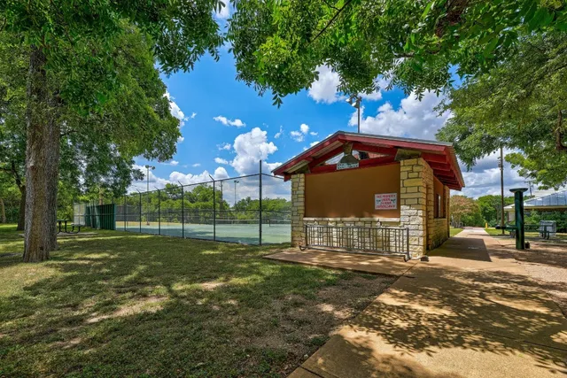 a view of a house with a yard and tree s