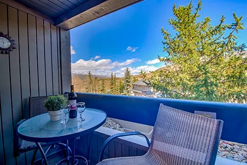 a view of a balcony with table and chairs