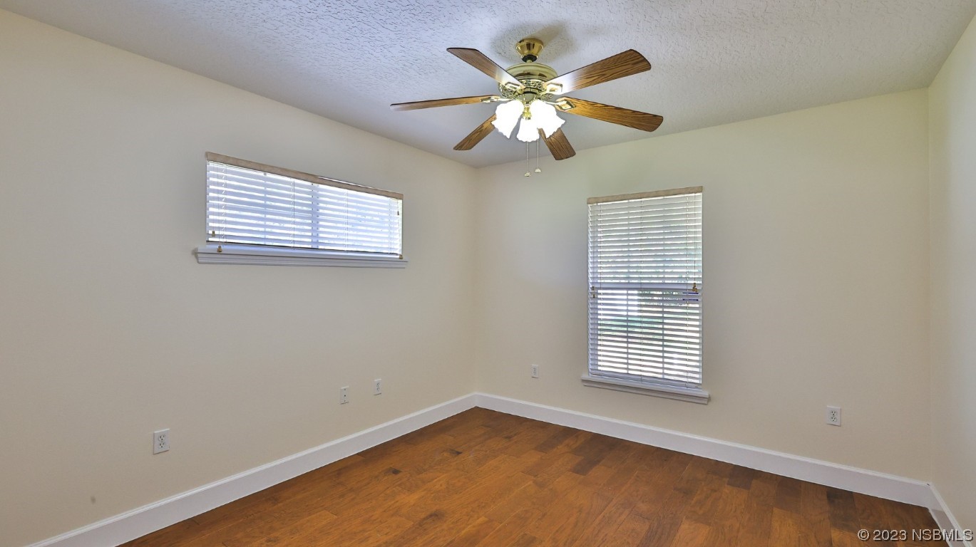 2655 Flowing Well Road DeLand, FL 32720 - Photo 11 of 23 an empty room with windows and fan