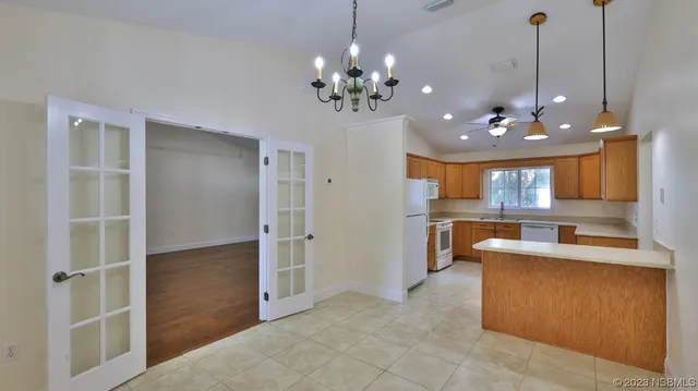 a view of a dining room with furniture and chandelier
