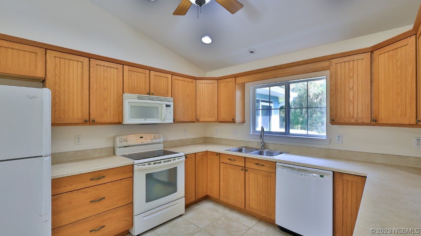 2655 Flowing Well Road DeLand, FL 32720 - Photo 14 of 23 a kitchen with granite countertop cabinets stainless steel appliances and sink