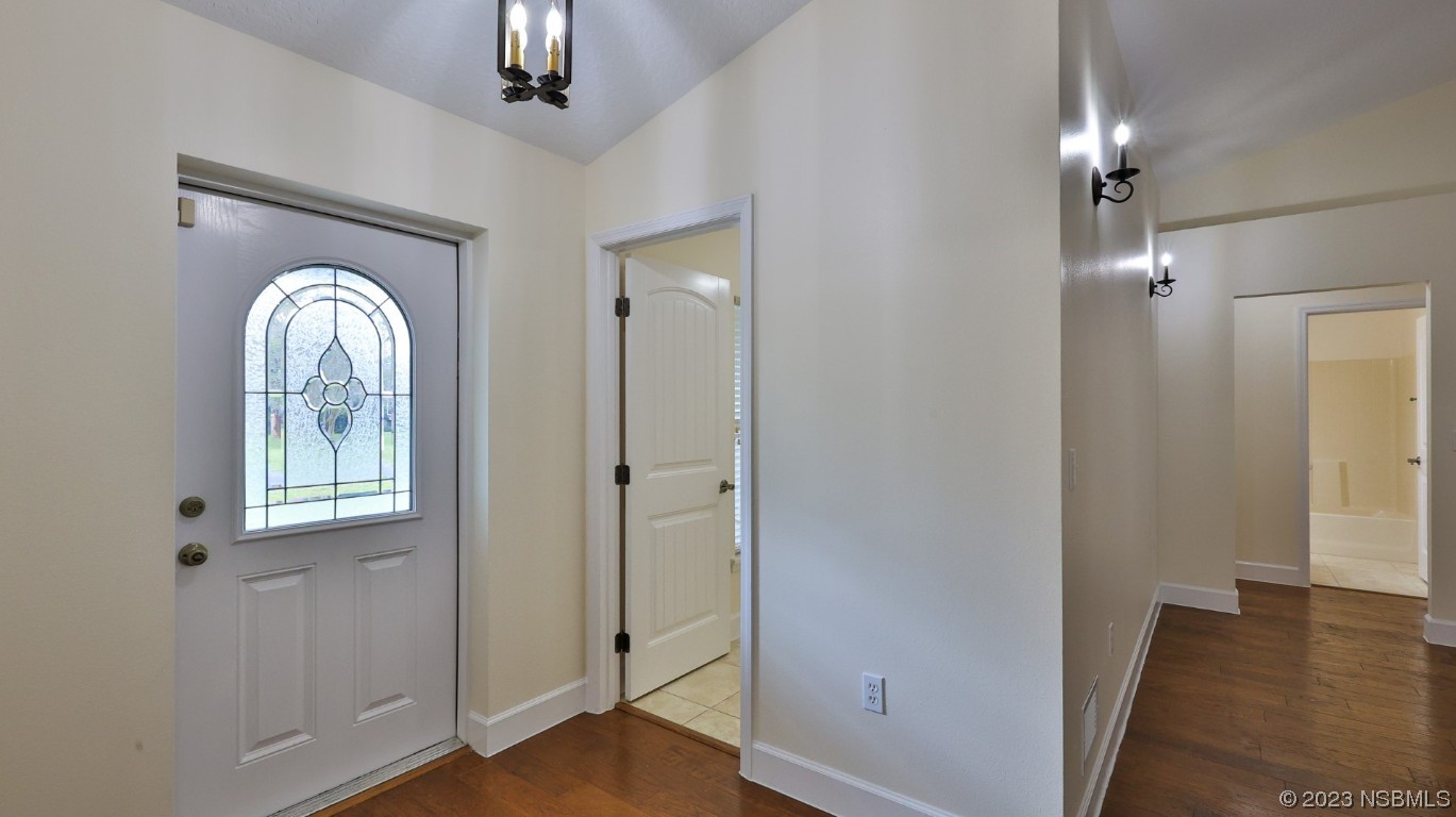 2655 Flowing Well Road DeLand, FL 32720 - Photo 19 of 23 a view of a livingroom with wooden floor and a large mirror