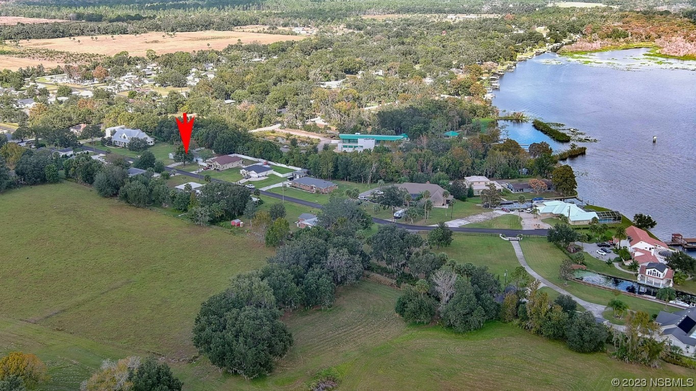 2655 Flowing Well Road DeLand, FL 32720 - Photo 20 of 23 a view of a lake with a yard