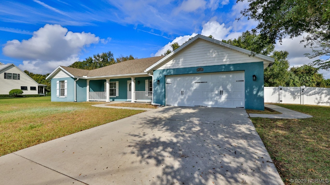 2655 Flowing Well Road DeLand, FL 32720 - Photo 2 of 23 a front view of a house with garden