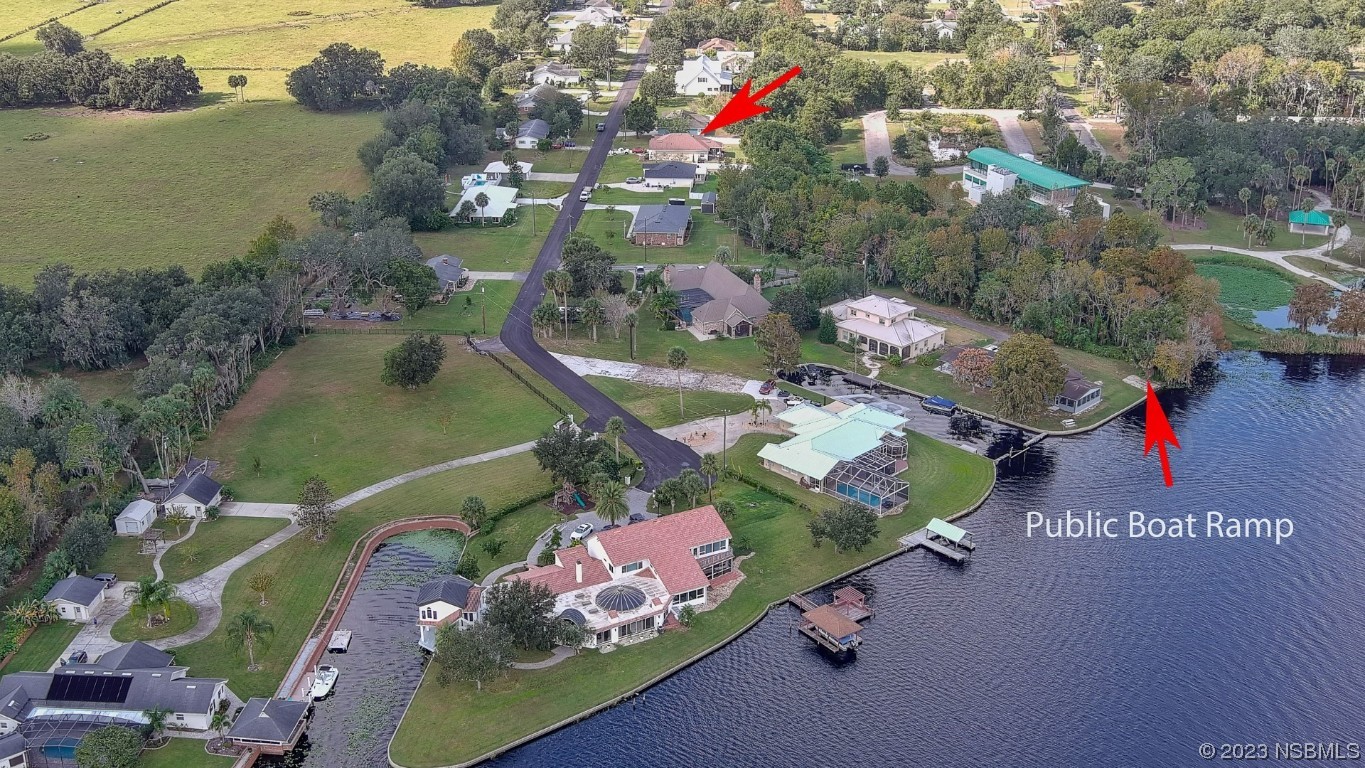 2655 Flowing Well Road DeLand, FL 32720 - Photo 23 of 23 an aerial view of a house with a lake view