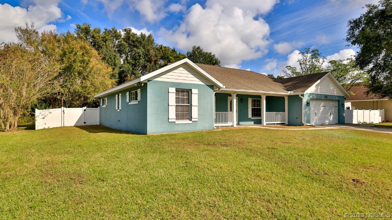 2655 Flowing Well Road DeLand, FL 32720 - Photo 4 of 23 a view of a house with a yard and garage