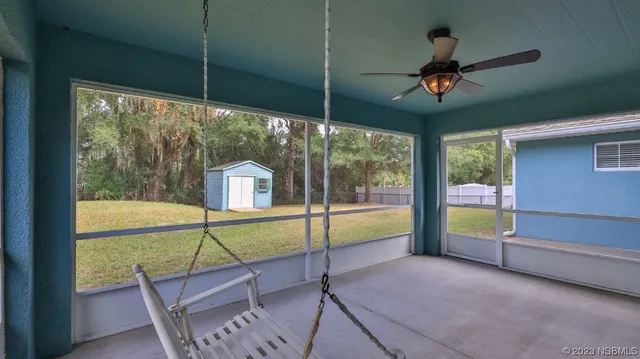a view of an empty room with windows