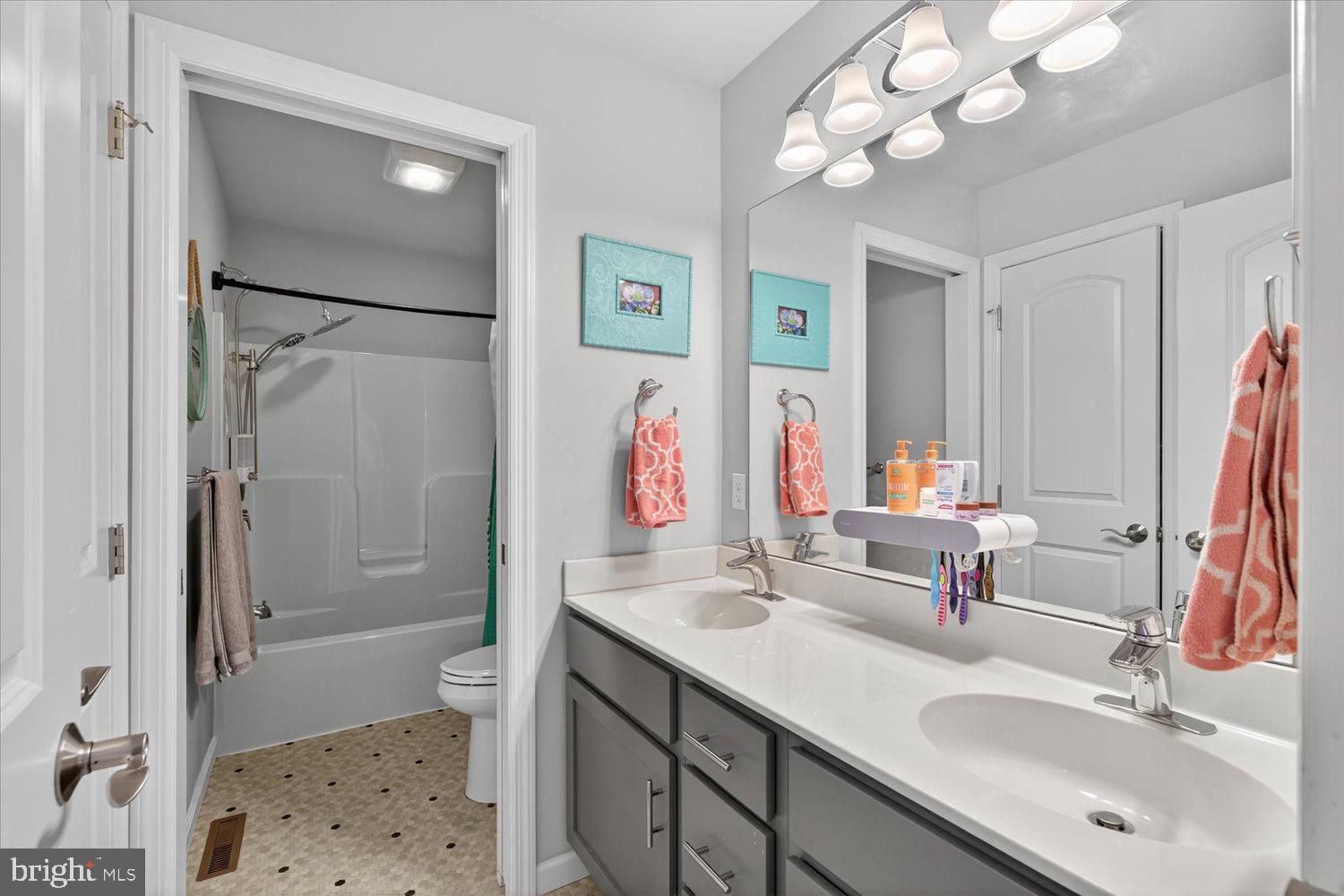 311 Ecker Drive Lititz, PA 17543 - Photo 34 of 49 a bathroom with a sink vanity mirror and toilet