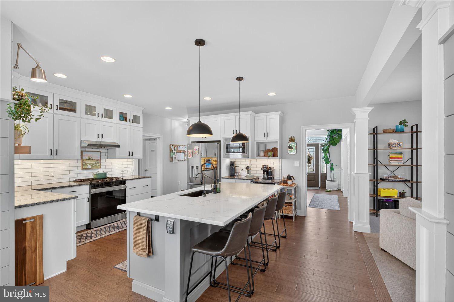 311 Ecker Drive Lititz, PA 17543 - Photo 6 of 49 a kitchen with stainless steel appliances kitchen island granite countertop a table chairs refrigerator and microwave