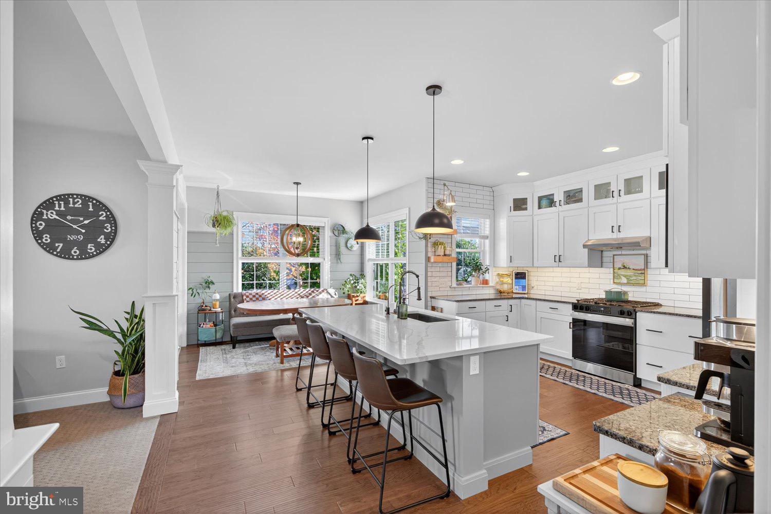 311 Ecker Drive Lititz, PA 17543 - Photo 7 of 49 a open dining room with stainless steel appliances kitchen island granite countertop a table chairs a sink dishwasher and a flat screen tv