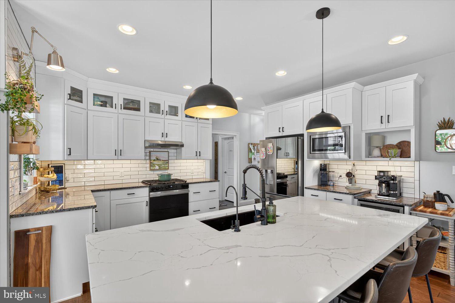 311 Ecker Drive Lititz, PA 17543 - Photo 8 of 49 a kitchen with a sink a stove and chairs