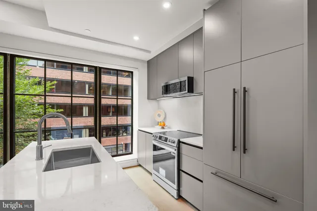 a kitchen with stainless steel appliances a refrigerator and a sink