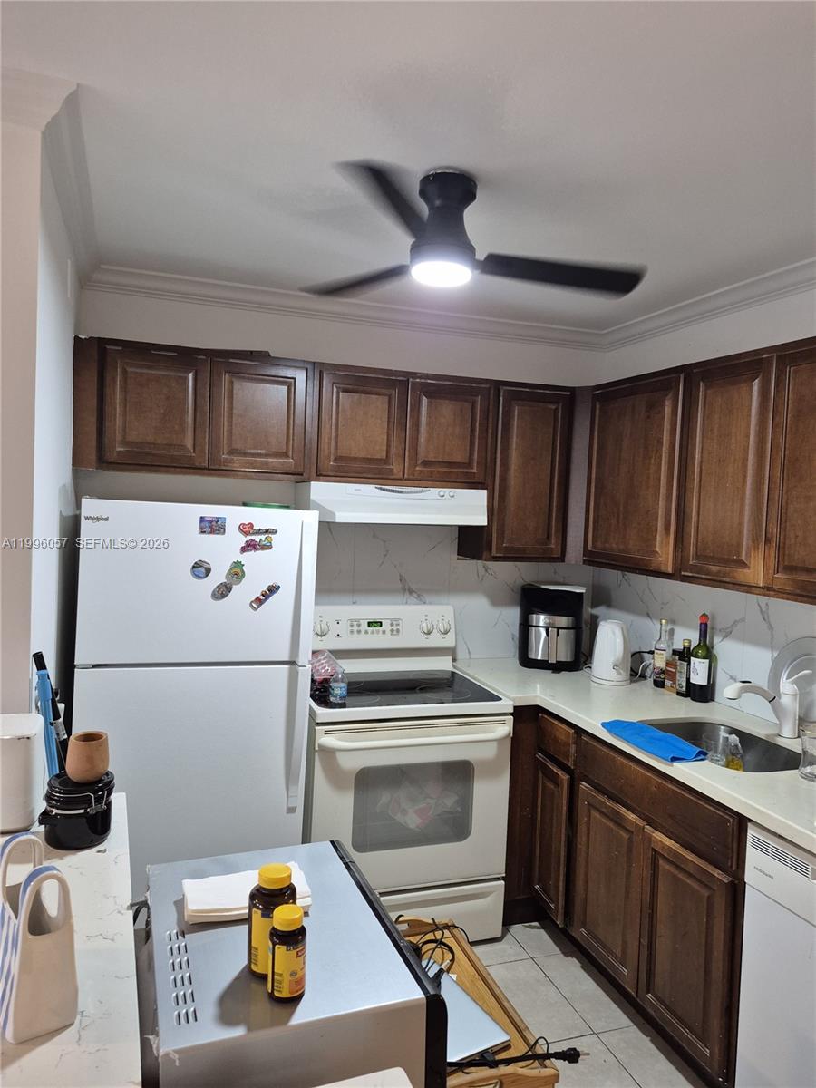 371 Brighton I, Unit 371 Boca Raton, FL 33434 - Photo 11 of 37 a kitchen with stainless steel appliances granite countertop a stove a sink dishwasher and a refrigerator with wooden cabinets