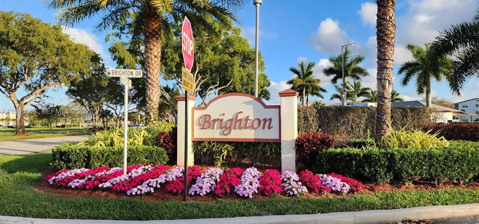 371 Brighton I, Unit 371 Boca Raton, FL 33434 - Photo 15 of 37 a sign that is in front of flowers