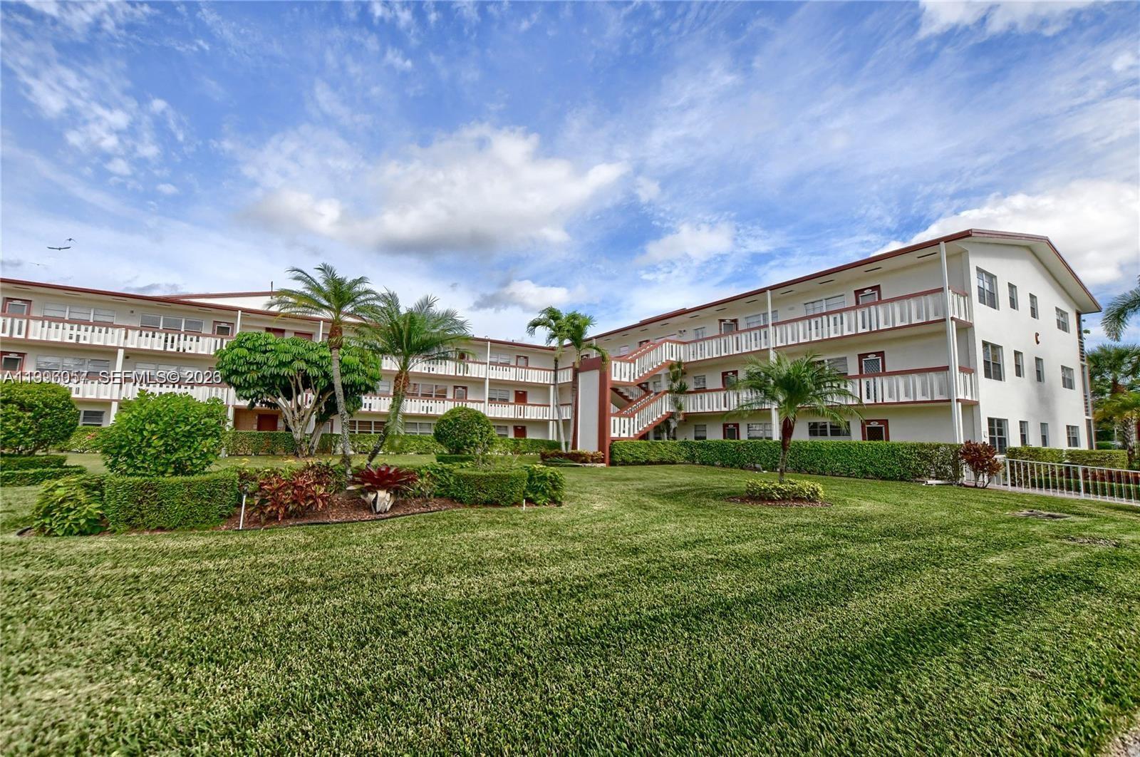 371 Brighton I, Unit 371 Boca Raton, FL 33434 - Photo 20 of 37 a view of a big building with garden and trees