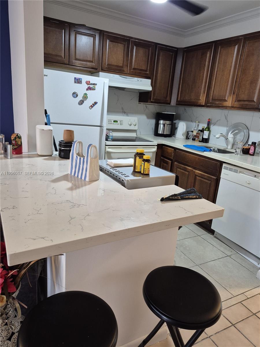 371 Brighton I, Unit 371 Boca Raton, FL 33434 - Photo 2 of 37 a kitchen with stainless steel appliances a stove a sink cabinets and a refrigerator