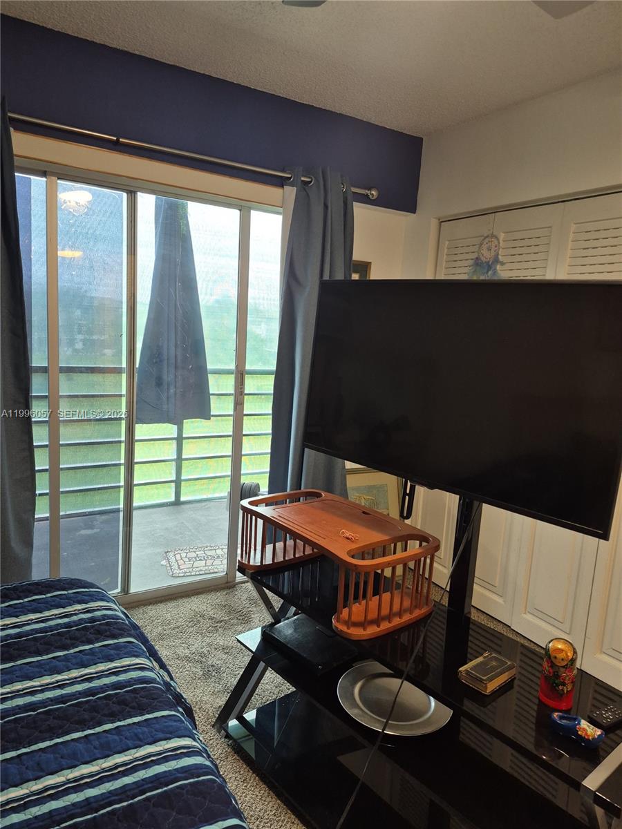 371 Brighton I, Unit 371 Boca Raton, FL 33434 - Photo 7 of 37 a room with furniture and a flat screen tv