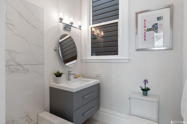a bathroom with a sink mirror and vanity