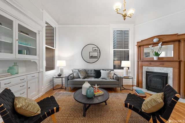 a living room with furniture a rug and a fireplace